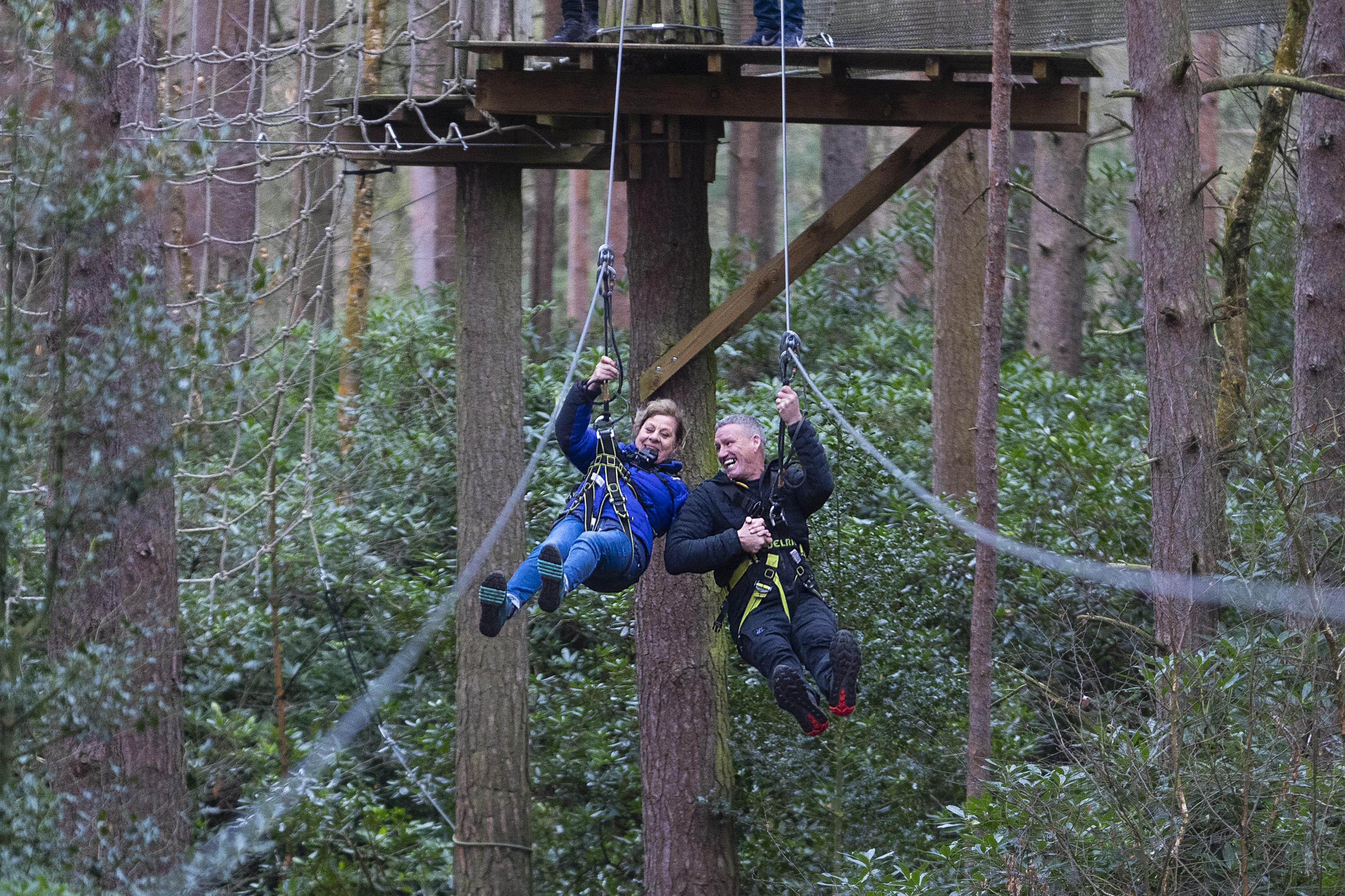 Tiggi and Billy Billingham taking part in a zip wire as they tackle the Go Ape assault course 