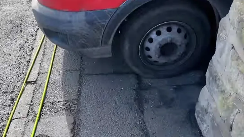 car blocking a narrow footpath