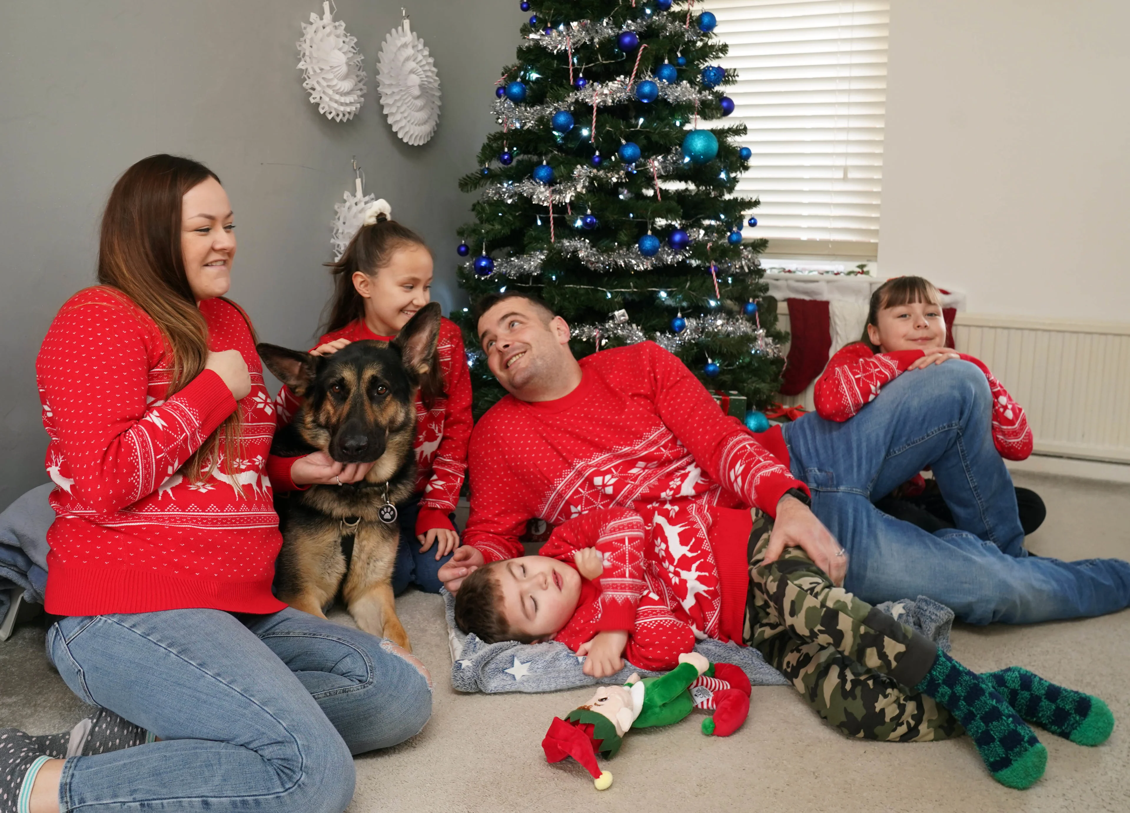 The Dodd Moore family with Buddy around the Christmas tree