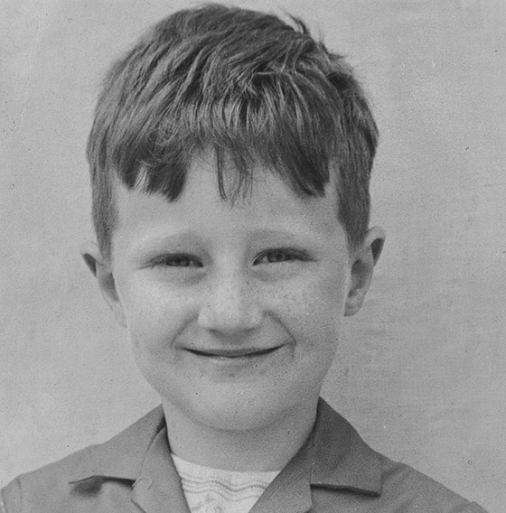 Paul O’Grady as a child smiling