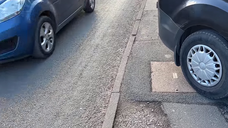 A van obstructing a footpath while a oncoming car drives past