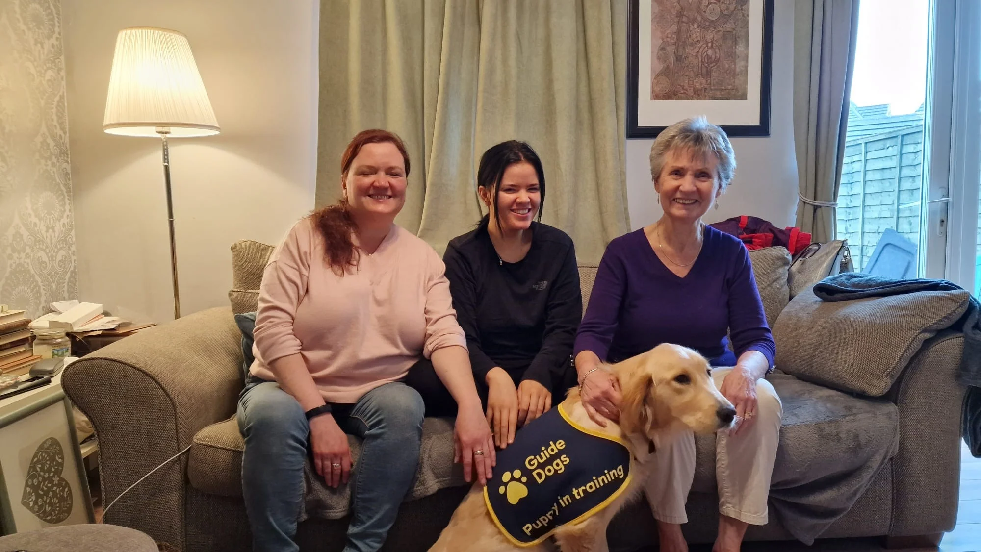 Cheryl, Ellie and Barbara Morgan with guide dog puppy Aura.