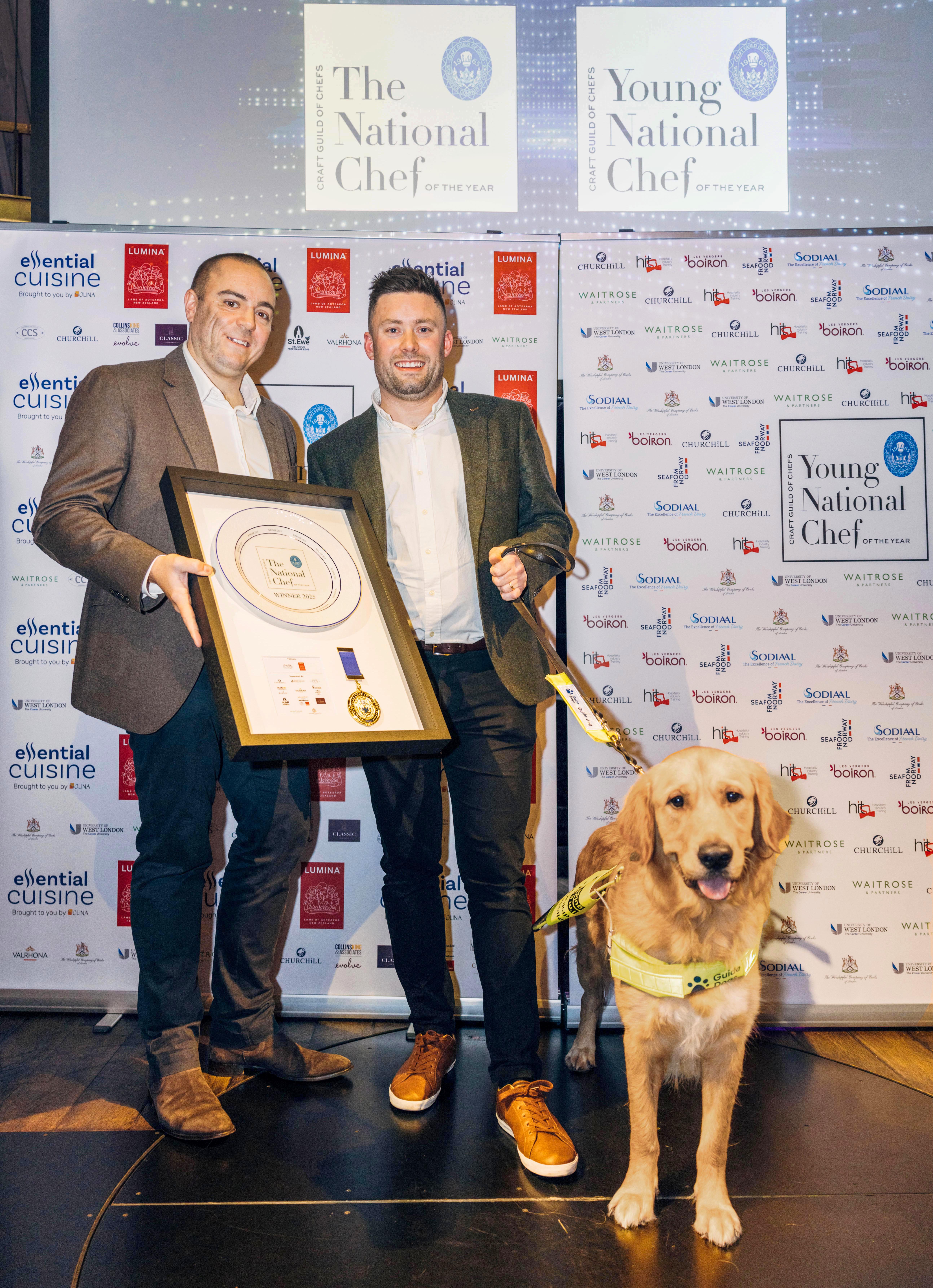 Golden retriever guide dog Bill stands with winners of the National Chef Awards