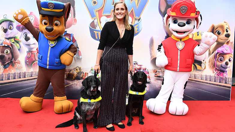 YouTuber Siobhan Meade with her guide dog Marty (right) and her partner’s guide dog, Sammy, on the red carpet with Paw Patrol characters Chase (left) and Marshall.