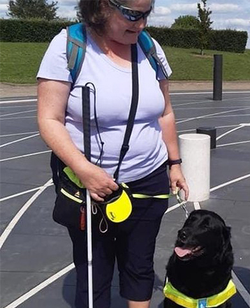 Guide dog owner Elaine and her black labrador guide dog Inca