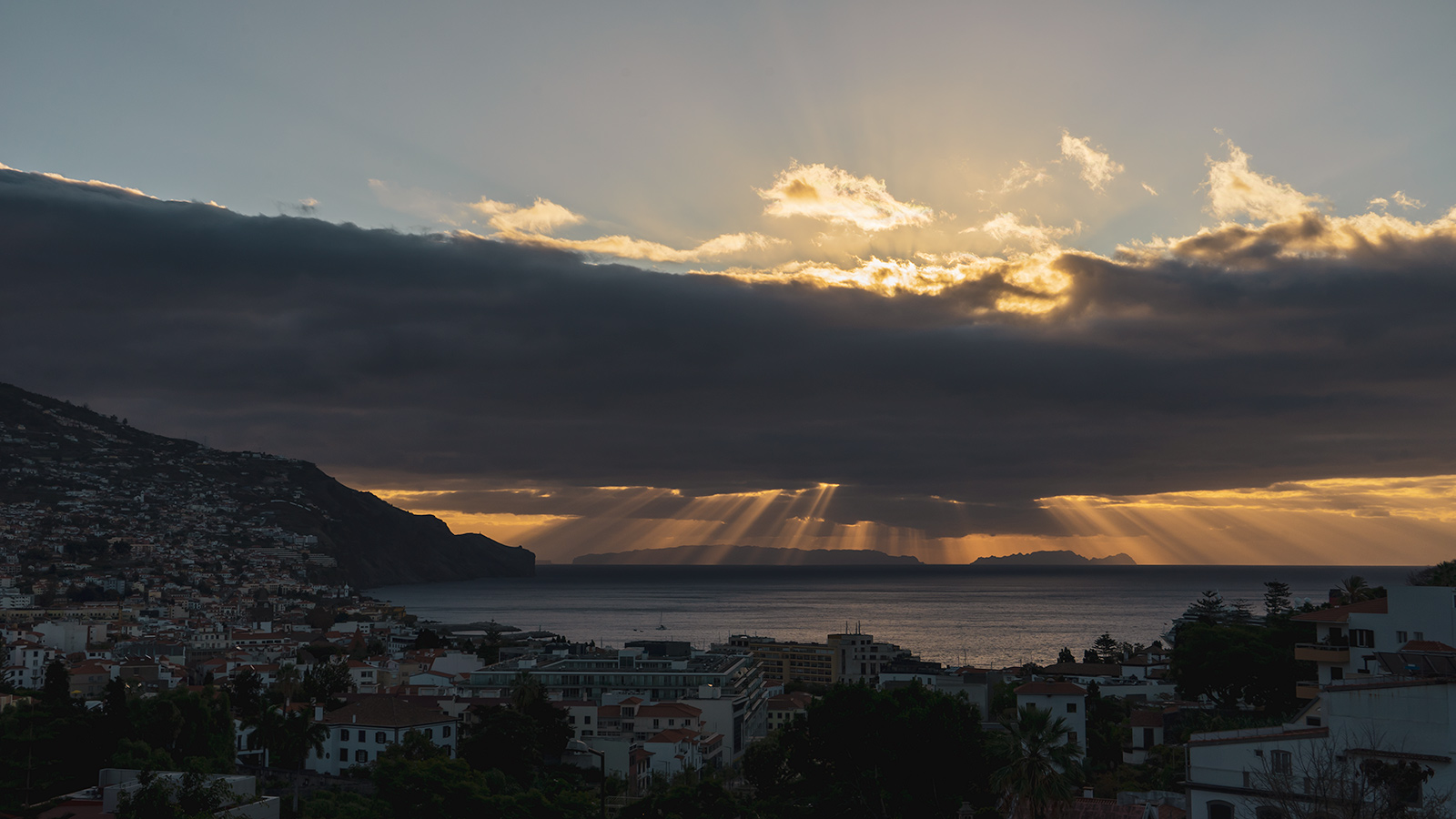 Sunrise at Funchal. Desertas Islands at the horizon.