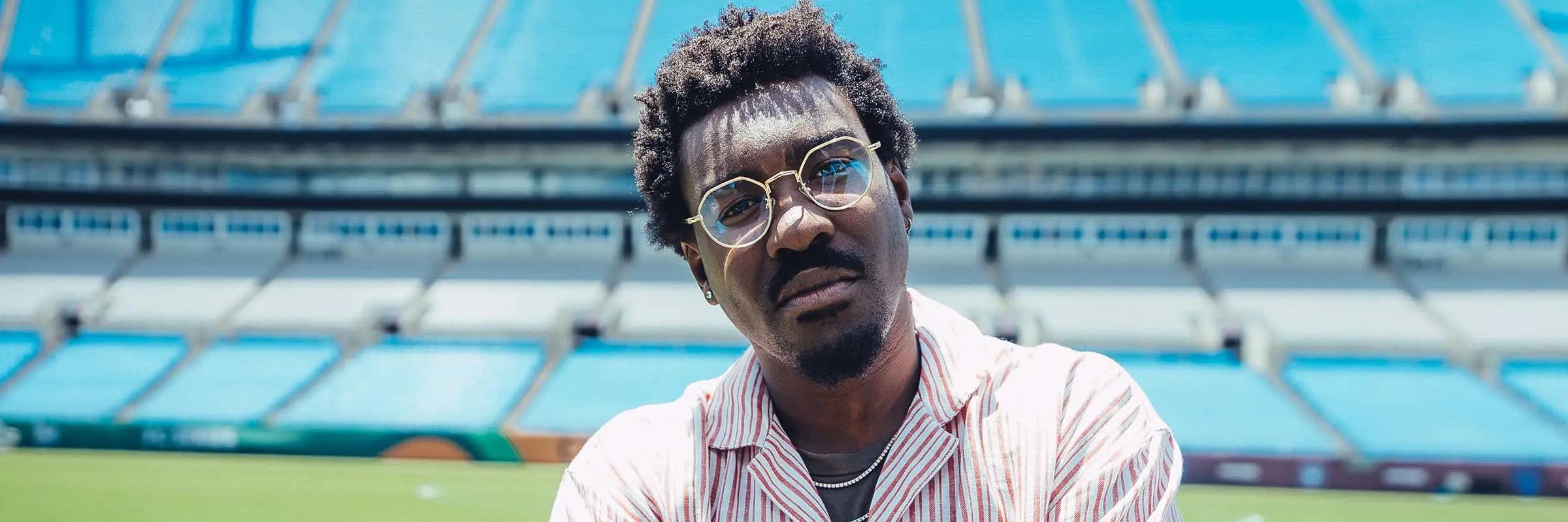 Charlotte FC commentator Lloyd Sam stands on the field at BoA Stadium