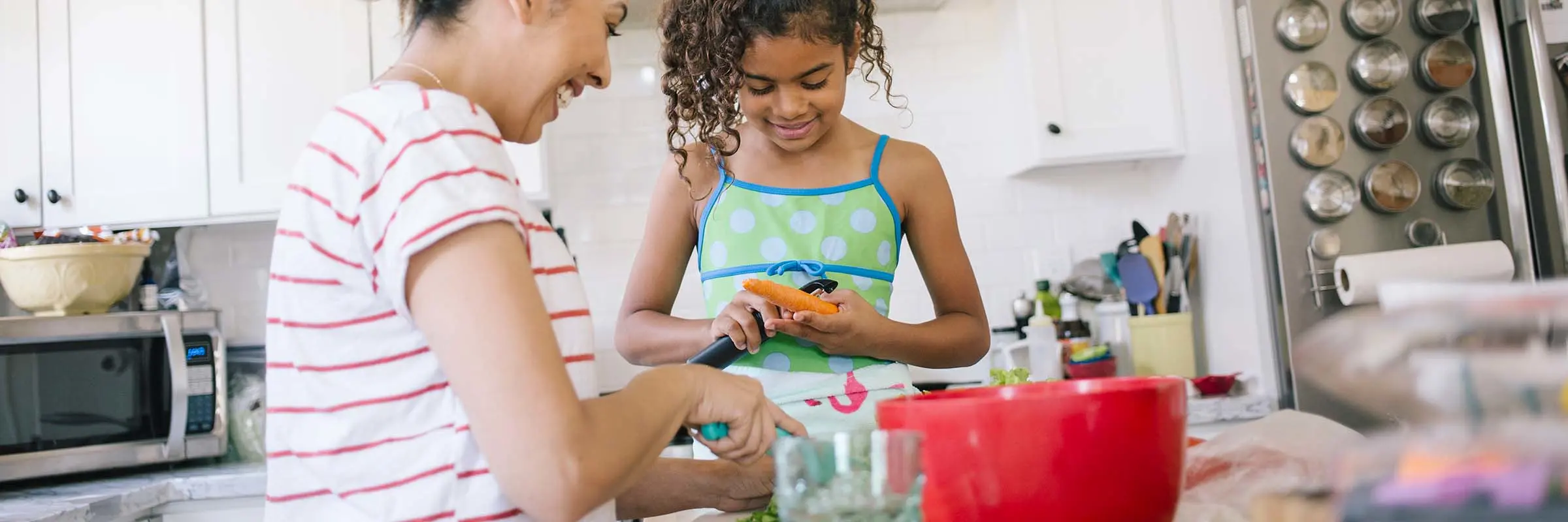 Mother and daughter prepping vegetables in the kitchen