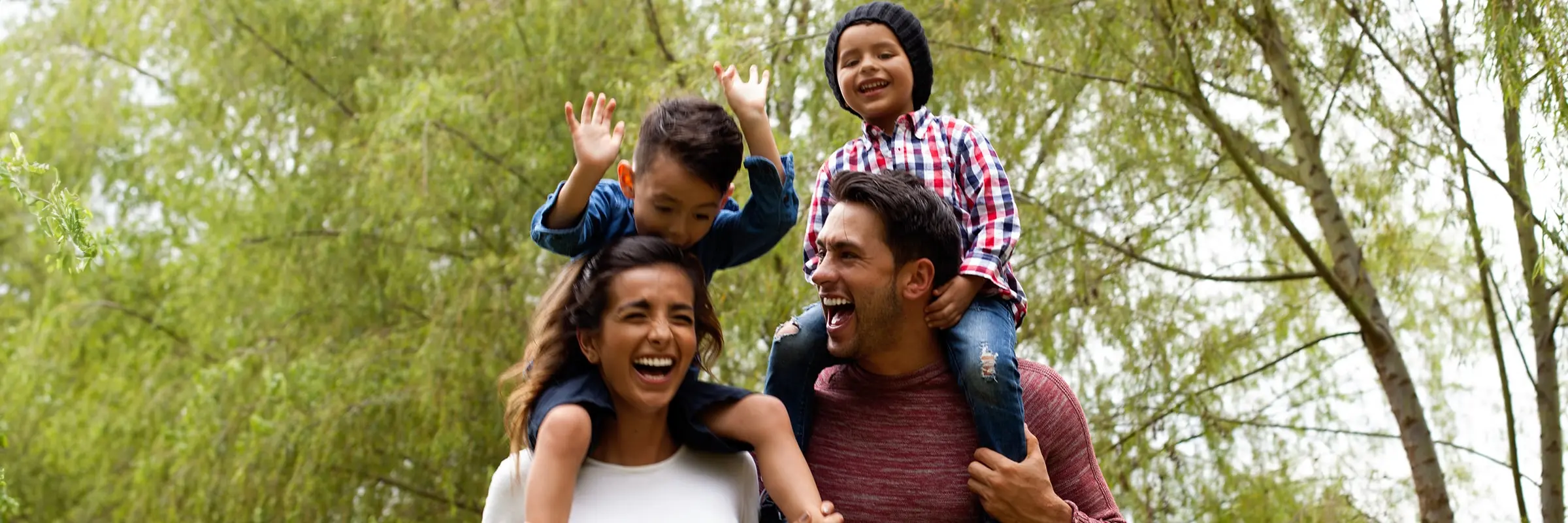 Family with two young kids take a walk on a wooded path