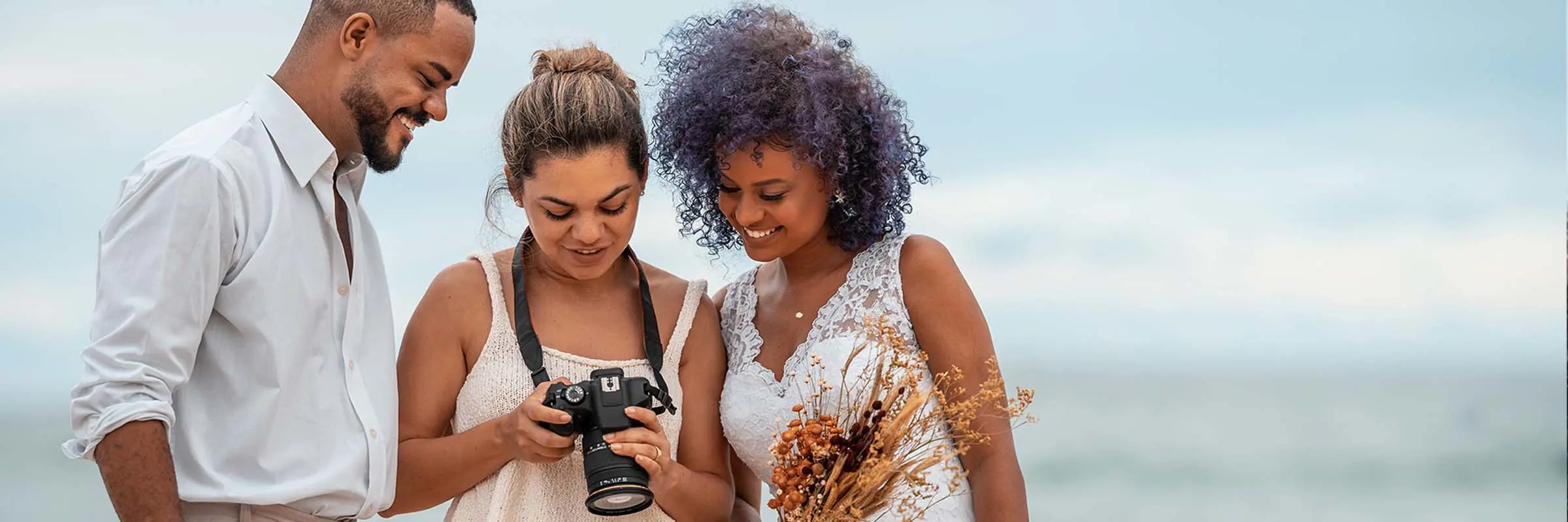 Photographer shows wedding photos to the bride and groom