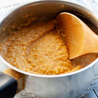 pumpkin oatmeal in a pot with wooden spoon 