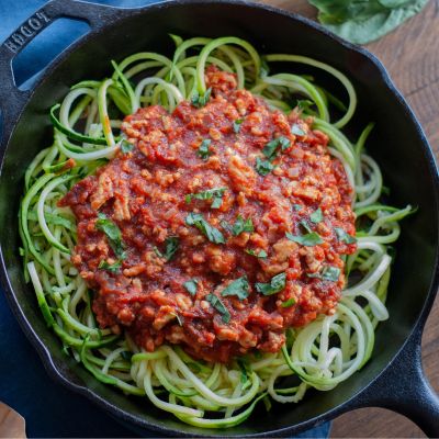 zucchini noodles with red sauce in a skillet 