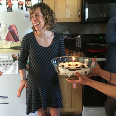 woman with birthday cake and candle