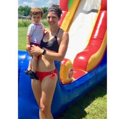 mother holding child in swimsuit 