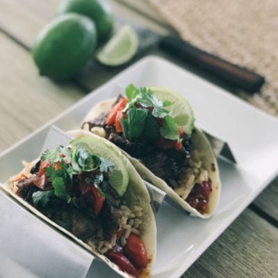 steak tacos with lime on a plate 