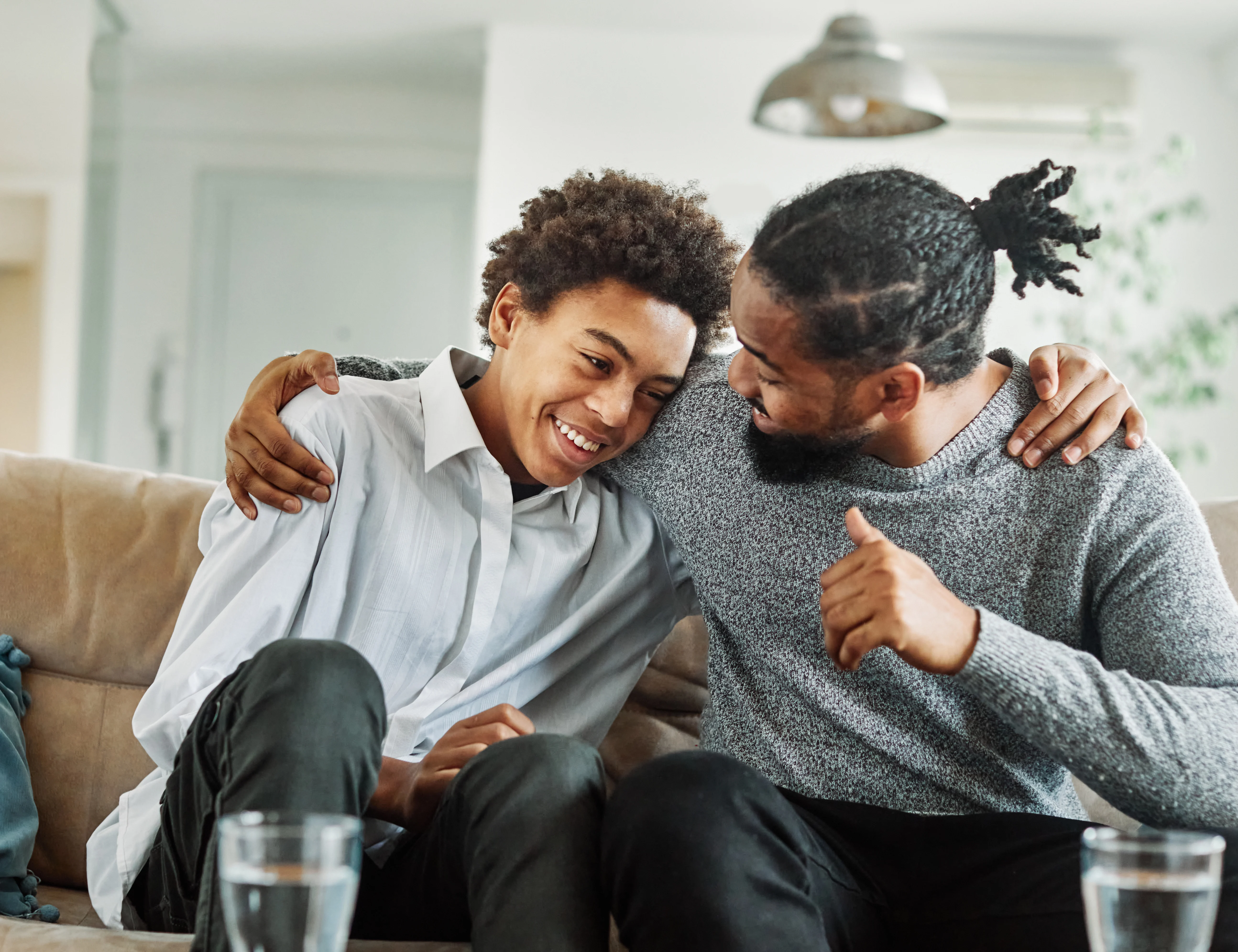 image of father and sun hugging and smiling