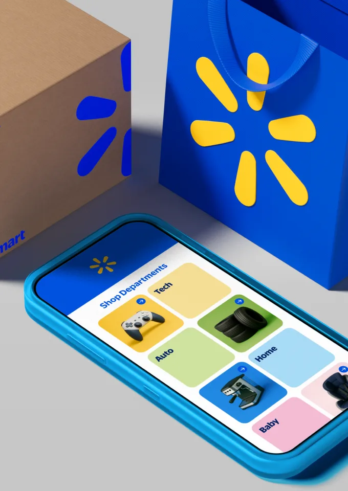 Brown box with blue Walmart logo on the left side next to bright blue Walmart bag with yellow logo. Blue iphone lays next to bag displaying popular shopping categories.