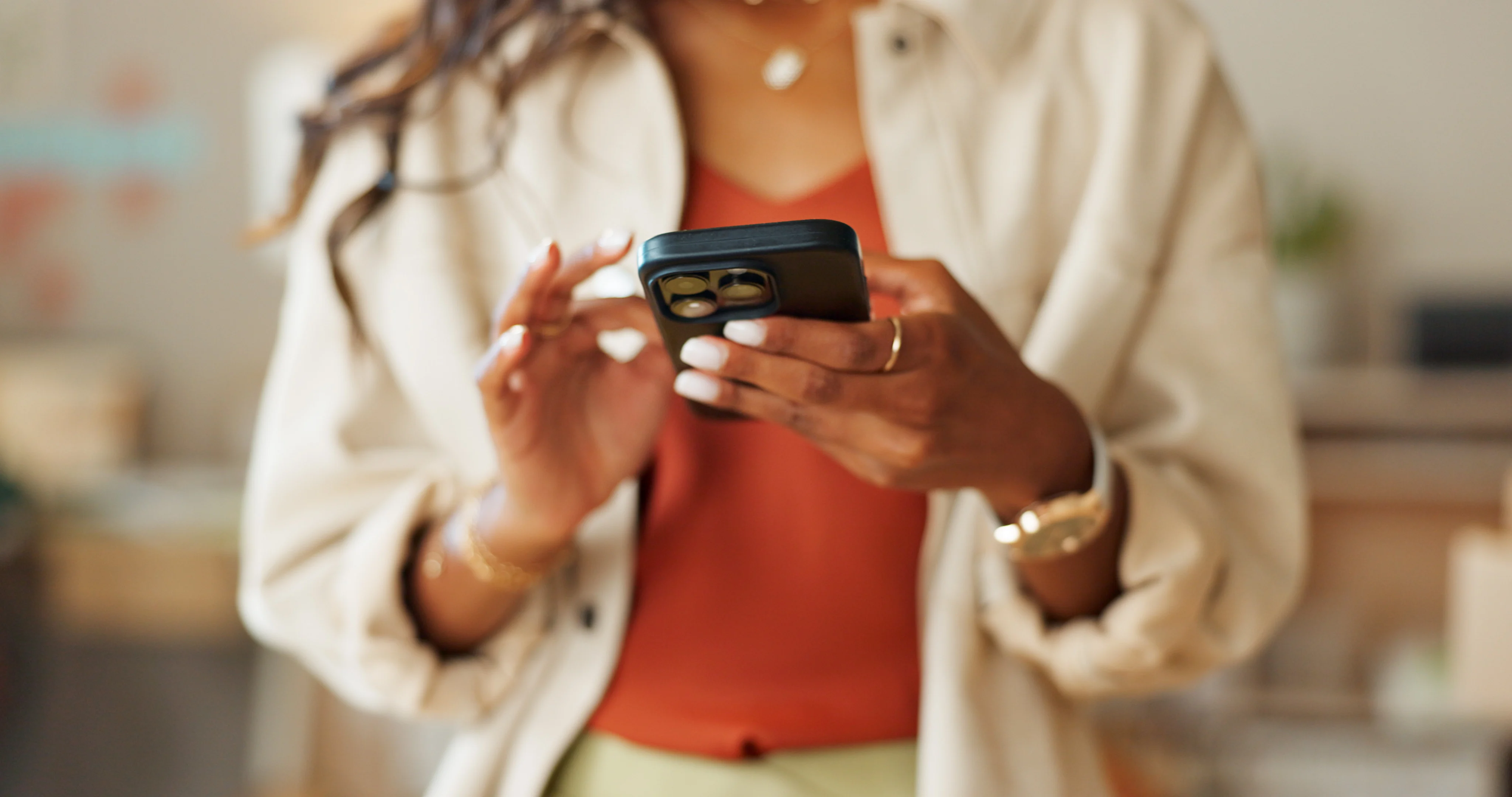 Woman with painted white names scrolling on her phone.