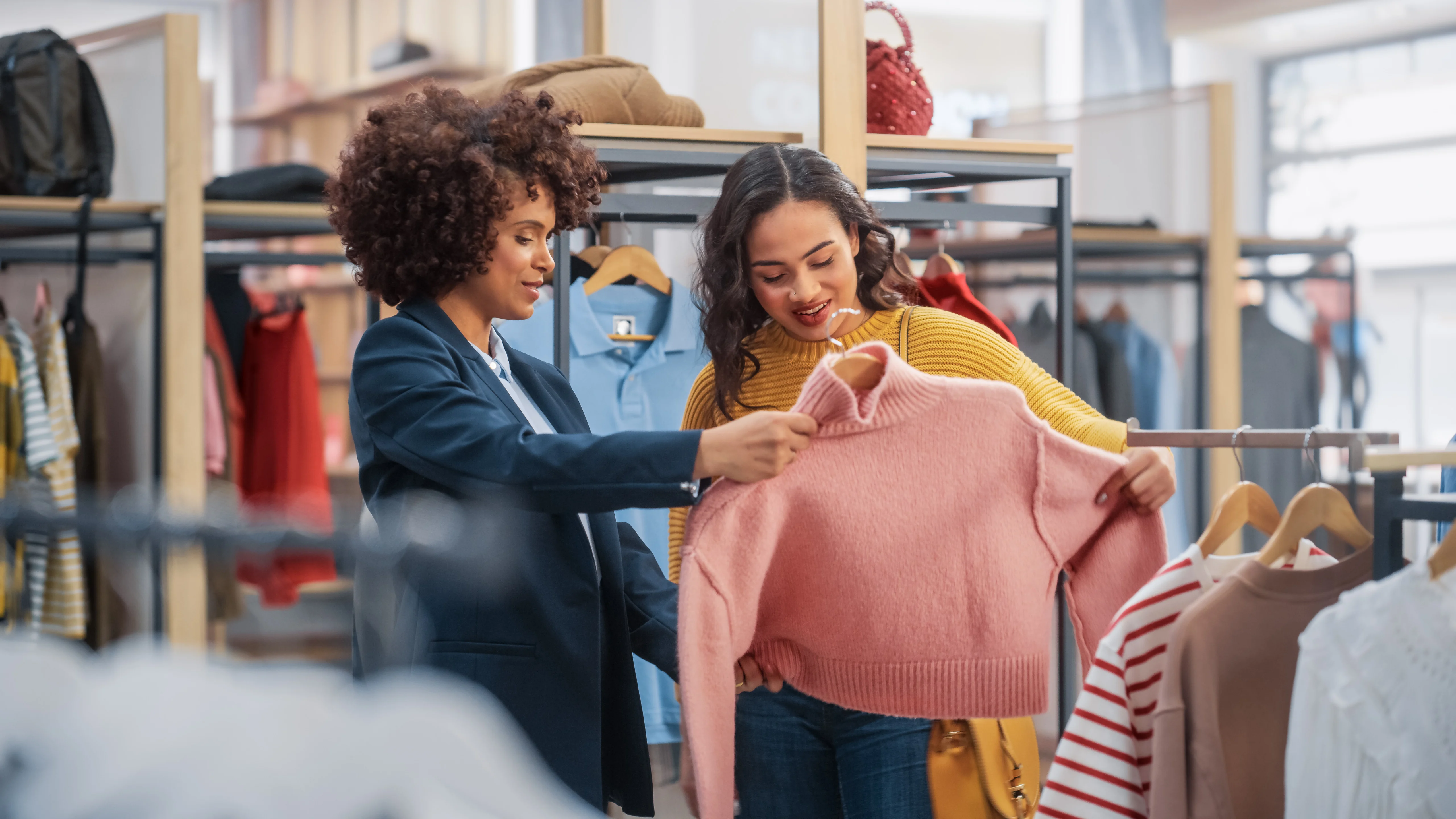 mother and daughter shopping, looking at sweater