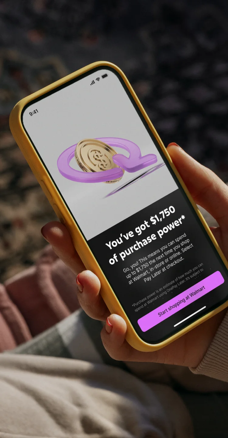 Yellow iphone displays image of a cold coin with a pink arrow around it. Below is text that reads user purchase power of $1,750 on a black background with a pink button at the bottom.