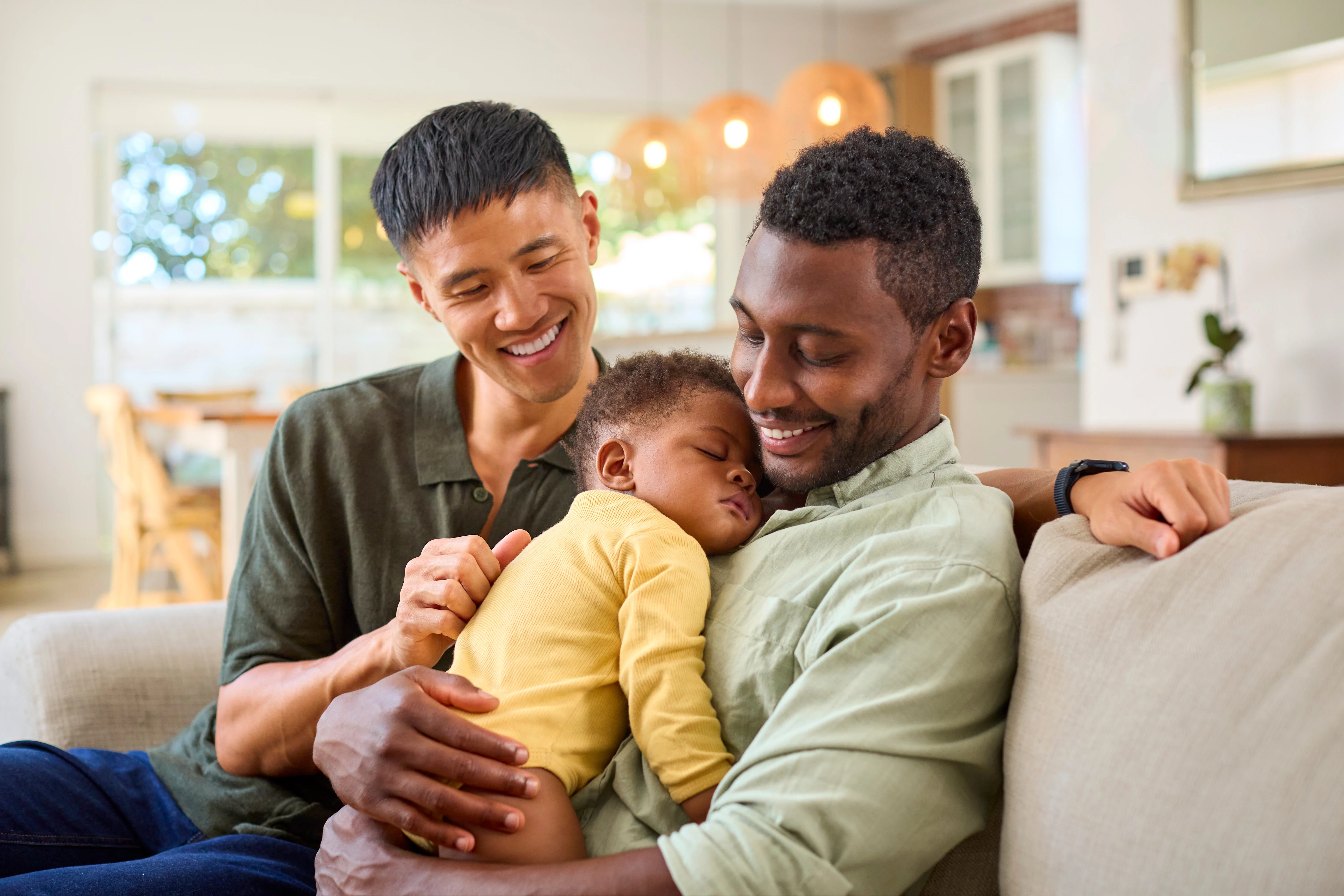 a couple on a couch with their newborn baby