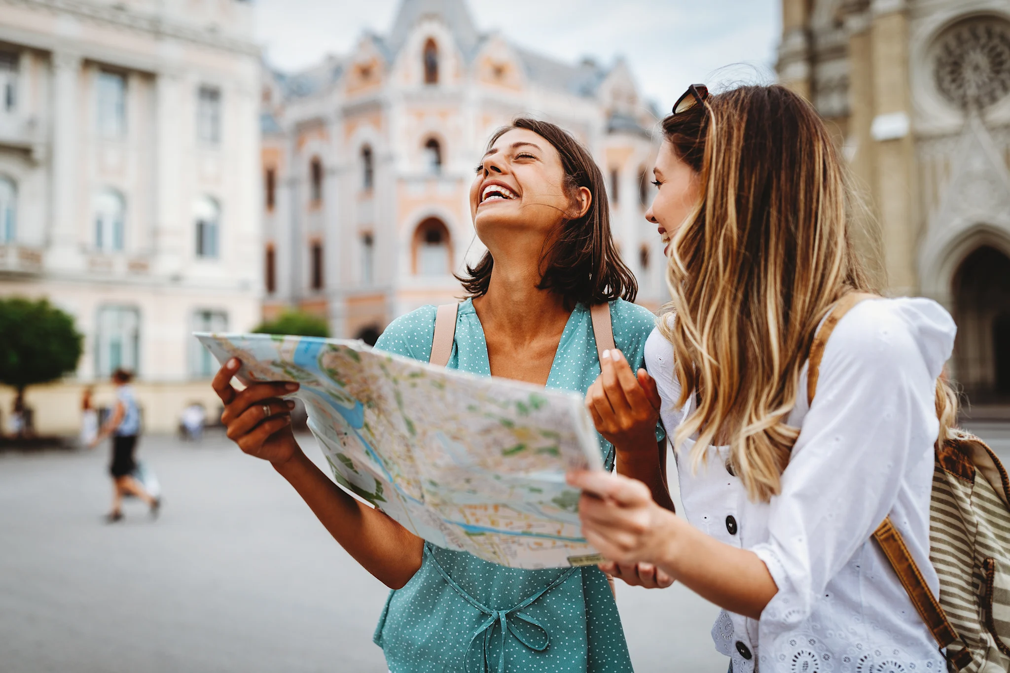 two friends laughing while traveling