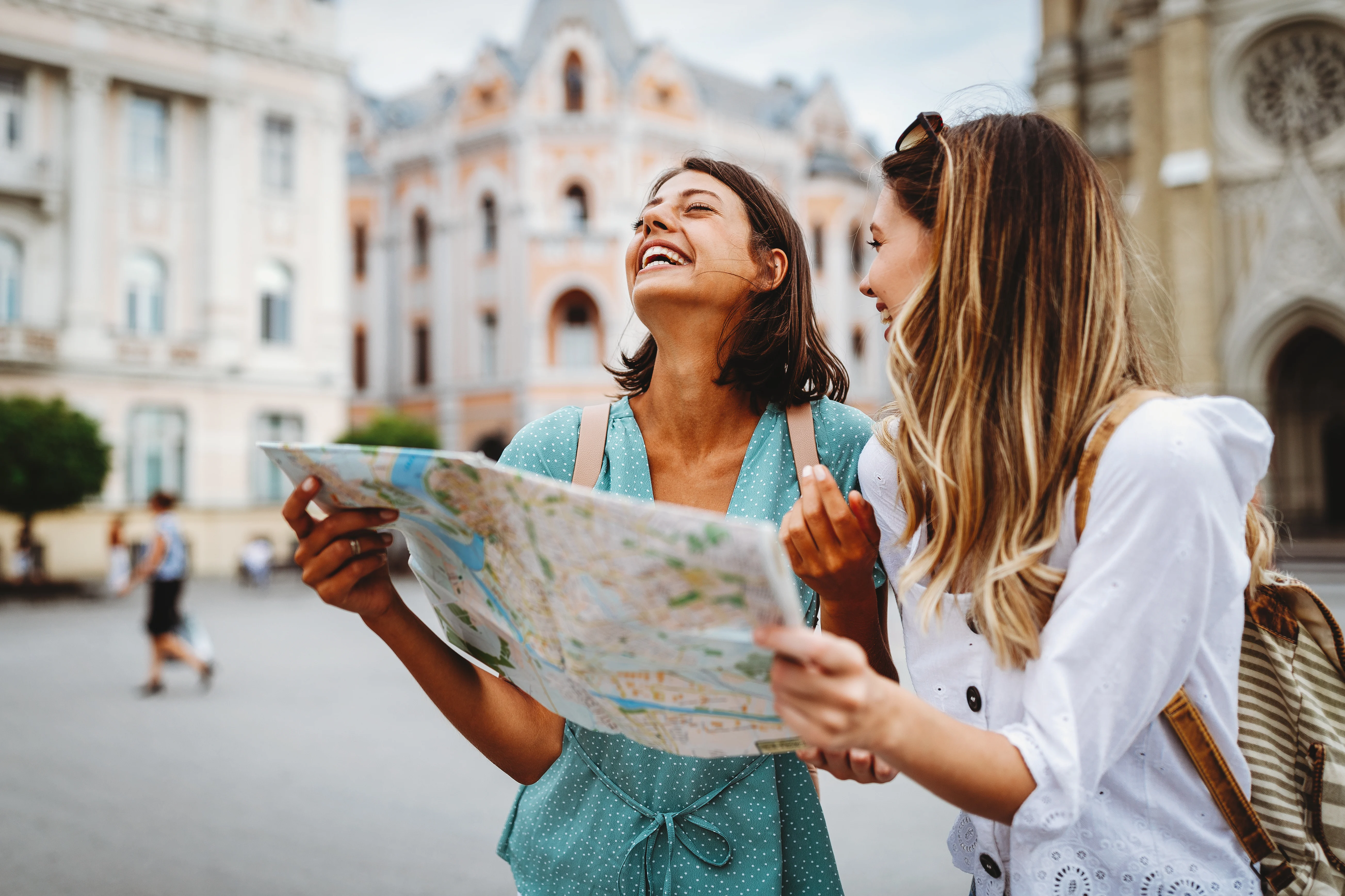 two friends laughing while traveling