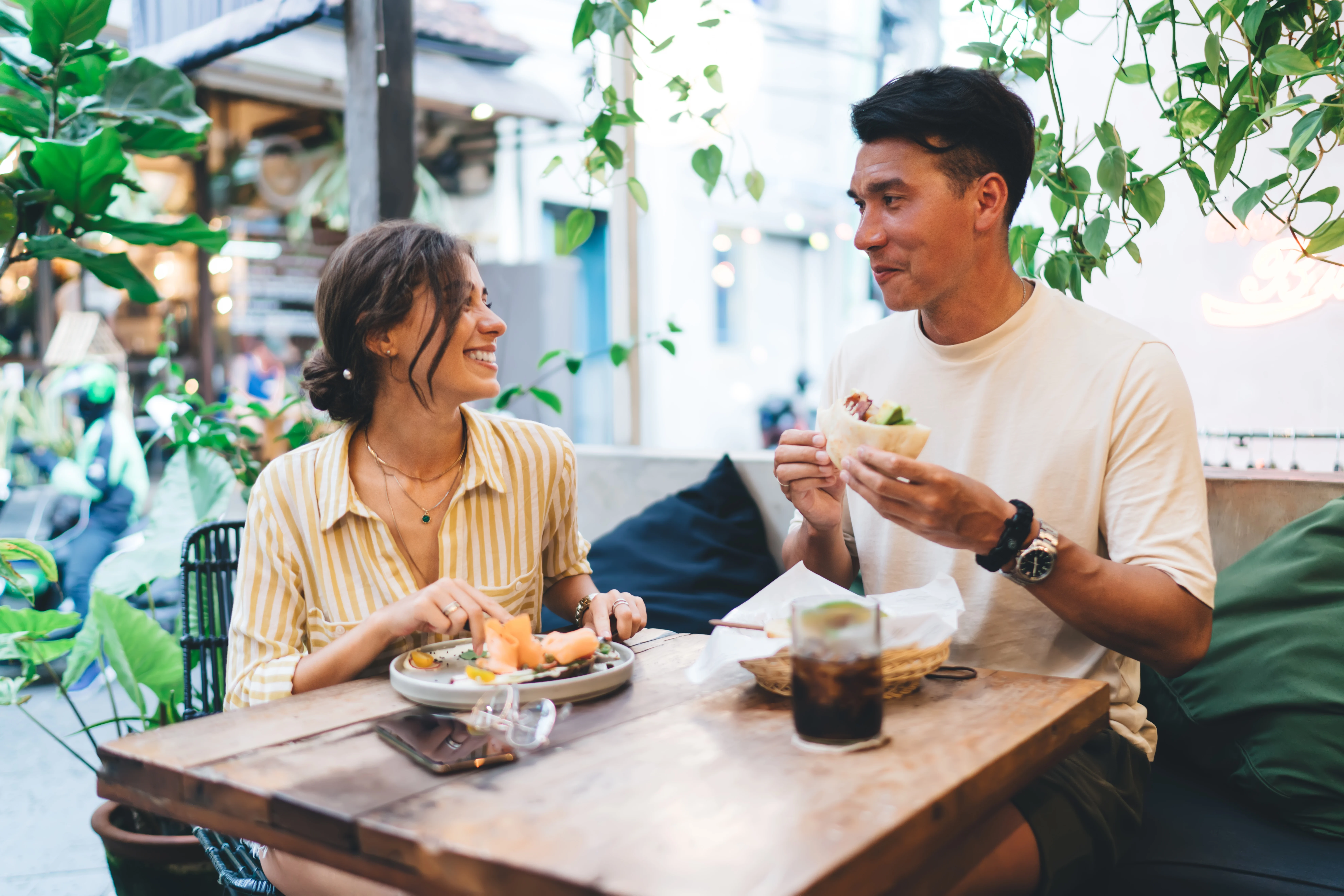 a couple eating outside at a restaurant