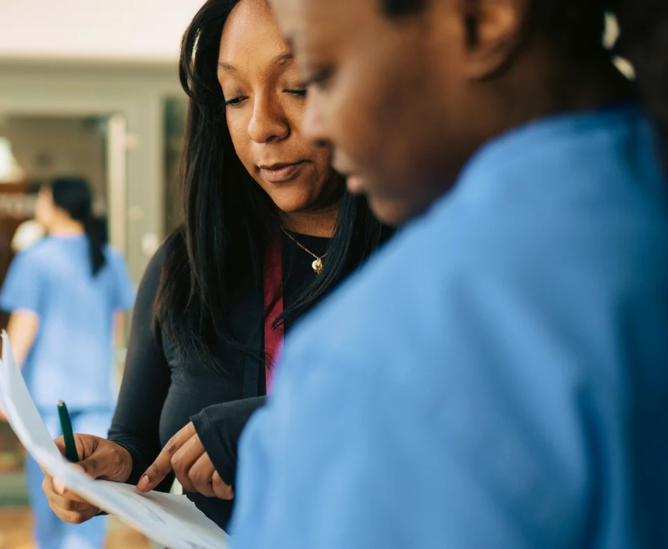 header-two-woman-healthcare-providers-d