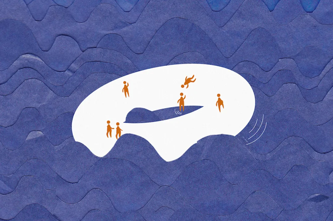 a group of people on on top of a donut shaped object which is floating on waves
