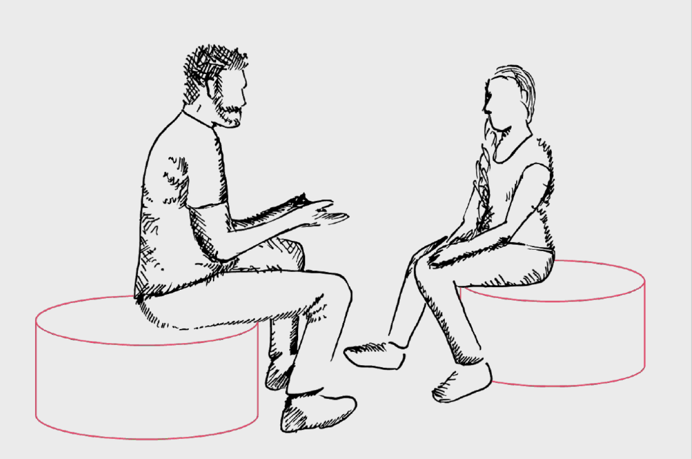two people sitting facing one another. they appear to be having a conversation 