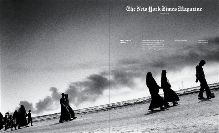 New York Times Magazine cover in black and white. Dark silhouettes of people walking in the desert