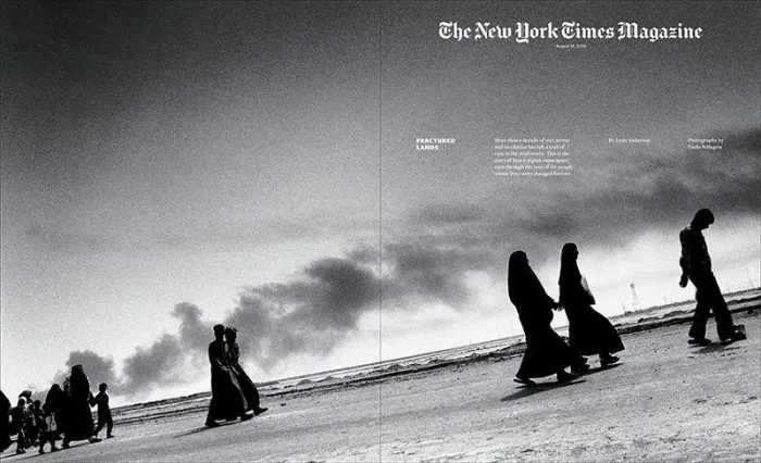 New York Times Magazine cover in black and white. Dark silhouettes of people walking in the desert