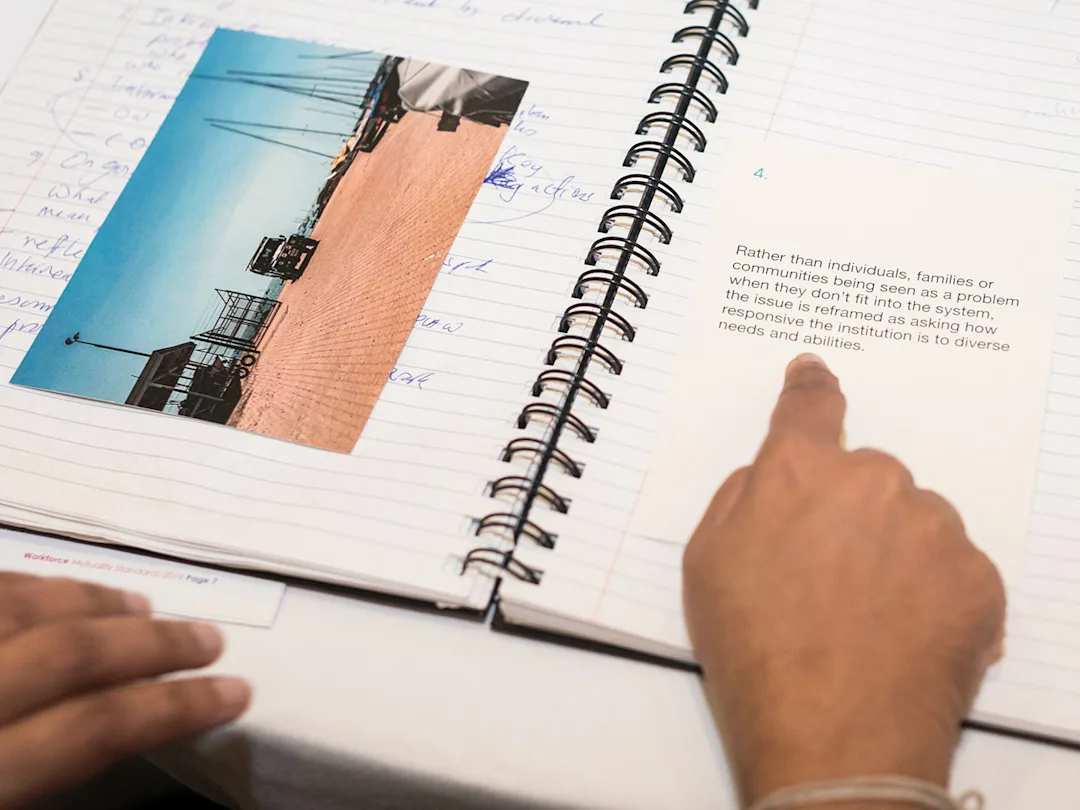 A photo from the co-design workshop showing a participants notebook with inspirational photo and statement on top.