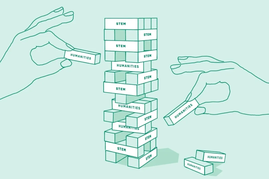 A game of Jenga is bein played. the blocks have the words "humanities and STEM" on them