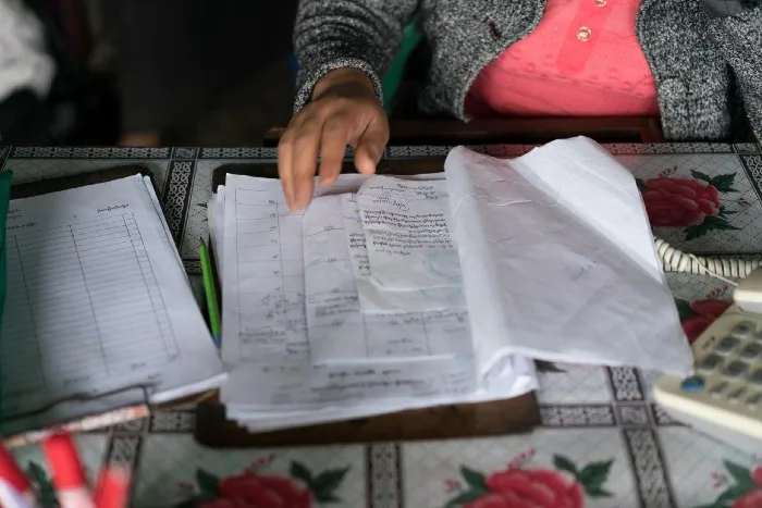 A research participant shows their family identity documents.
