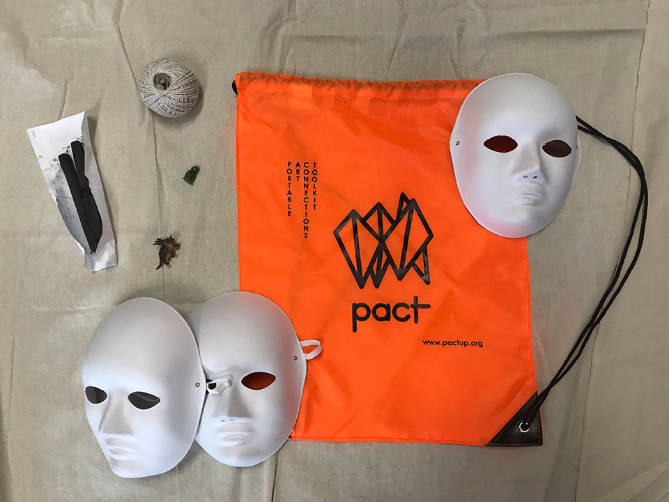 The Pact Artkit featuring 3 face masks, string charcoal and a bright orange bag.