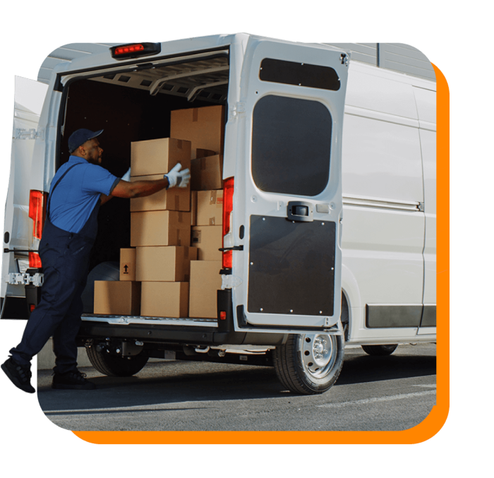 Worker loading a delivery truck with boxes