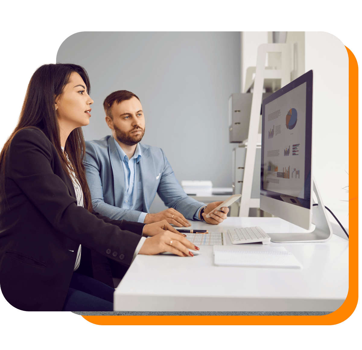 Two business people reviewing an analytics dashboard together at a computer