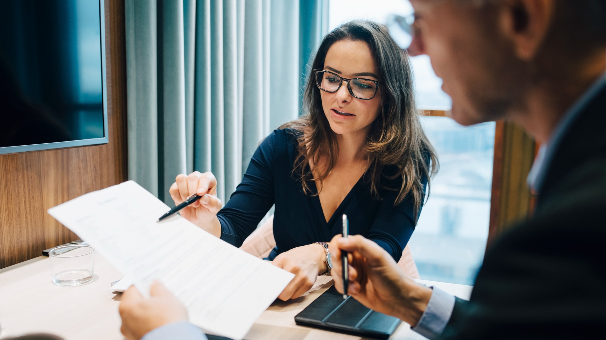 Man and woman reviewing requirements on paper