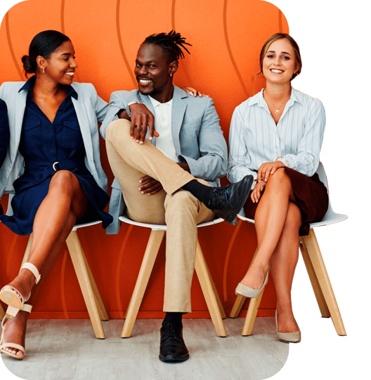 Three business people sitting next to each other with their legs crossed