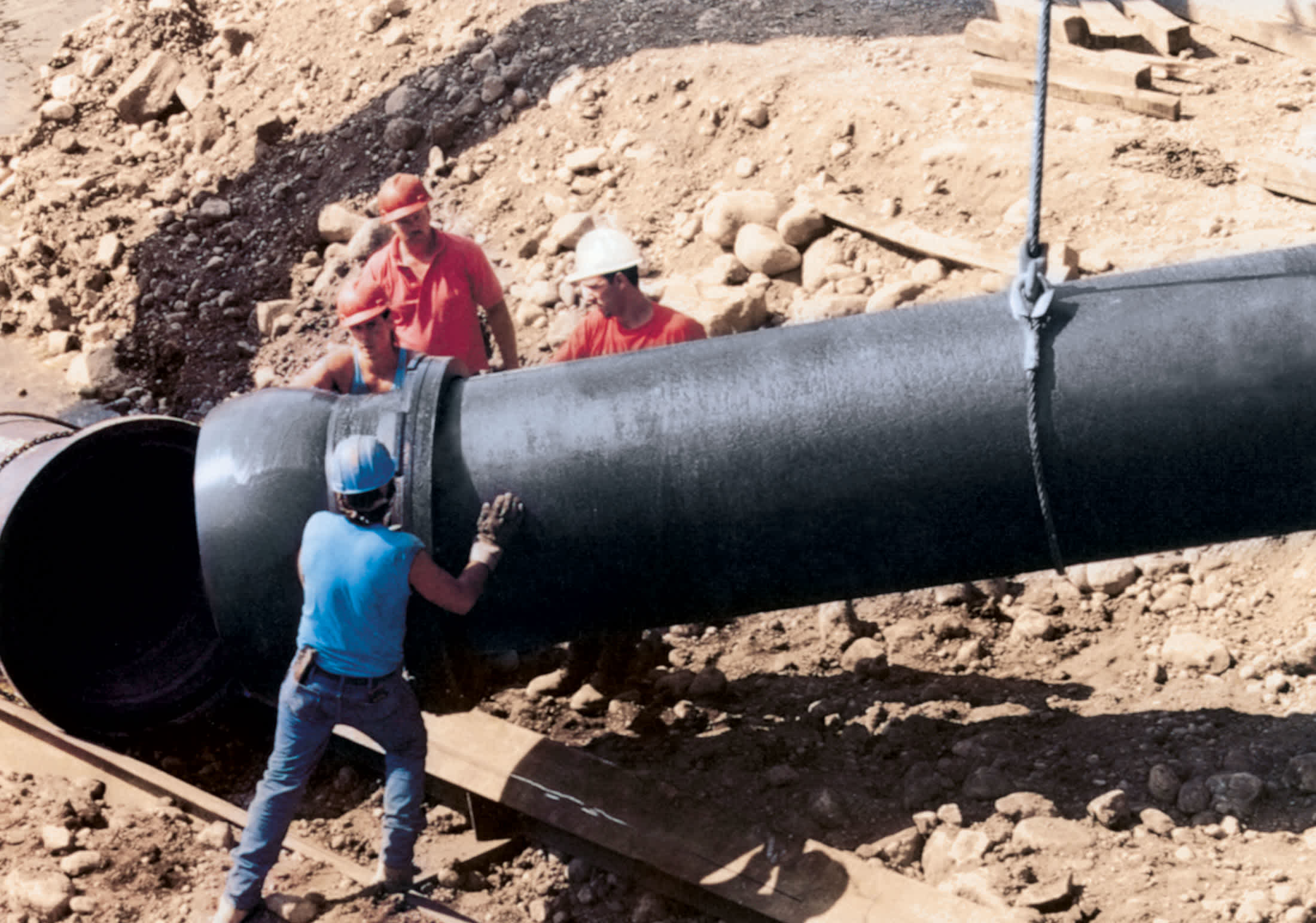 Crew install large Ductile iron pipe