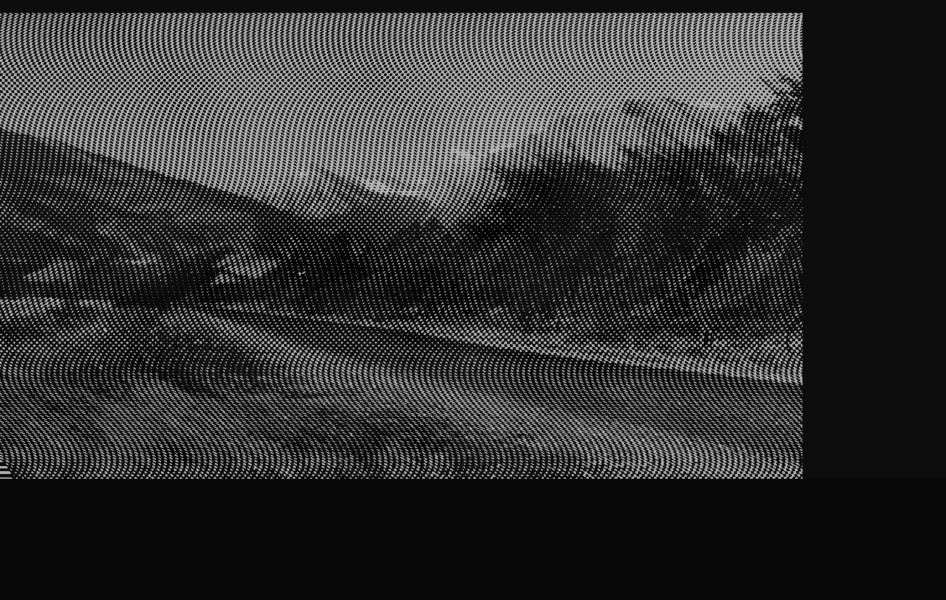 aliased black and white image of a road running through mountainous countryside