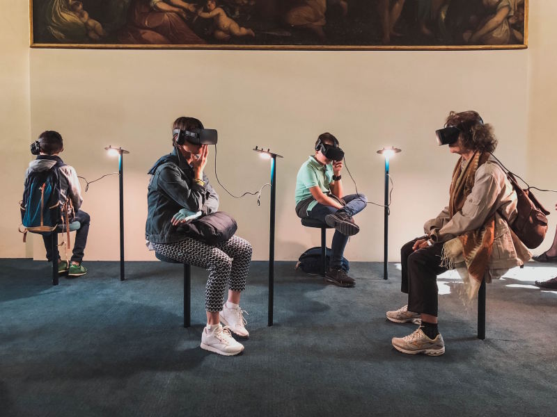 Four people using VR headsets.