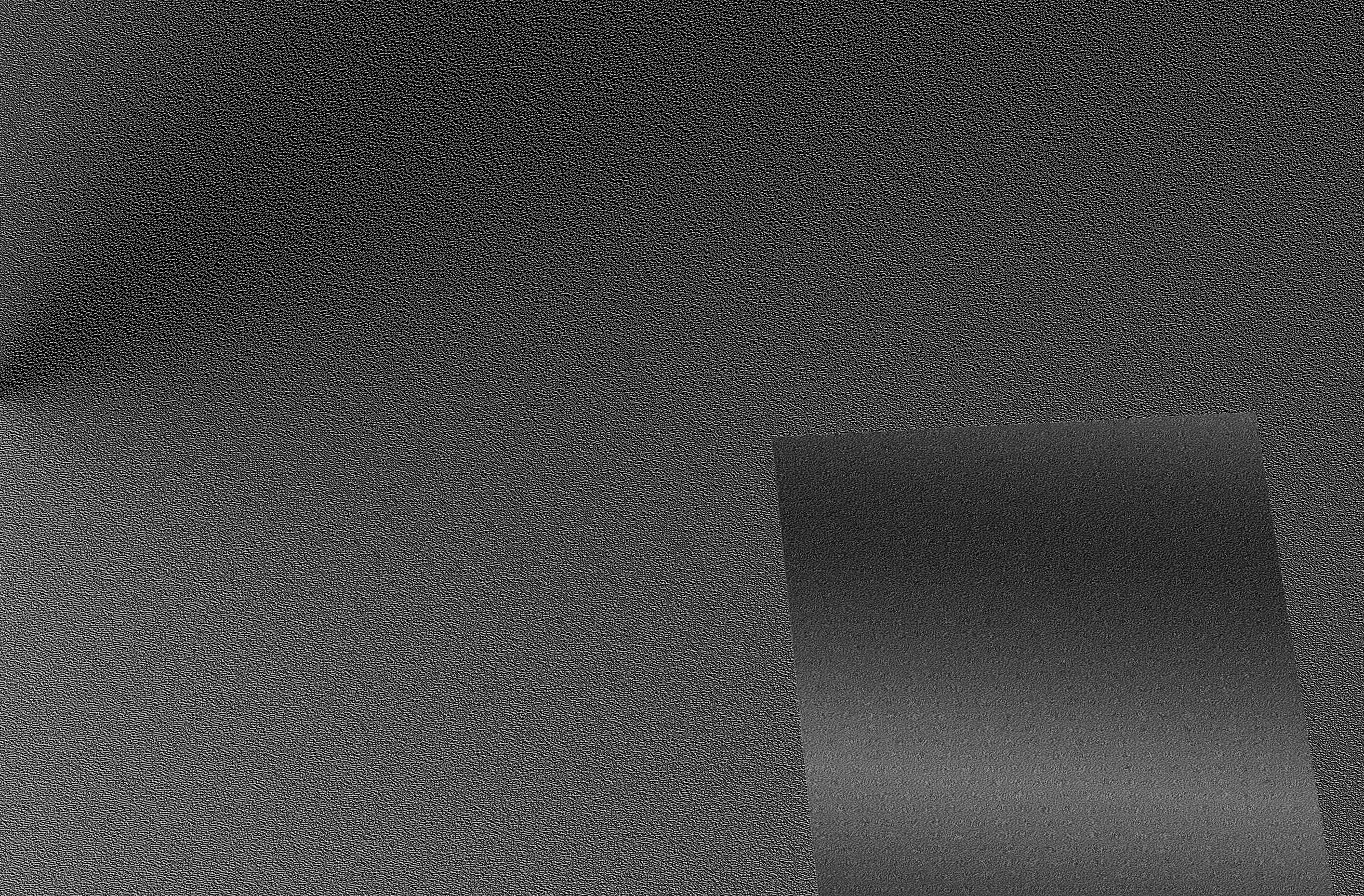 An abstract image of a greyscale gradient triangle on top of a greyscale gradient background.