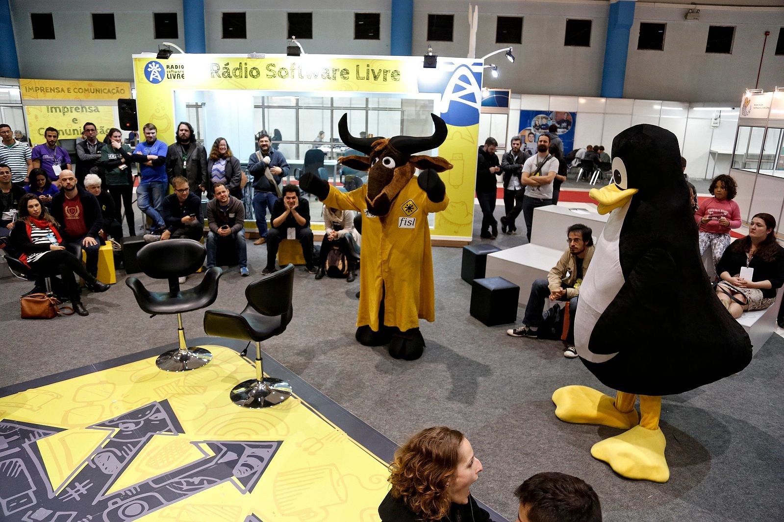 Two mascots entertain a group of people.