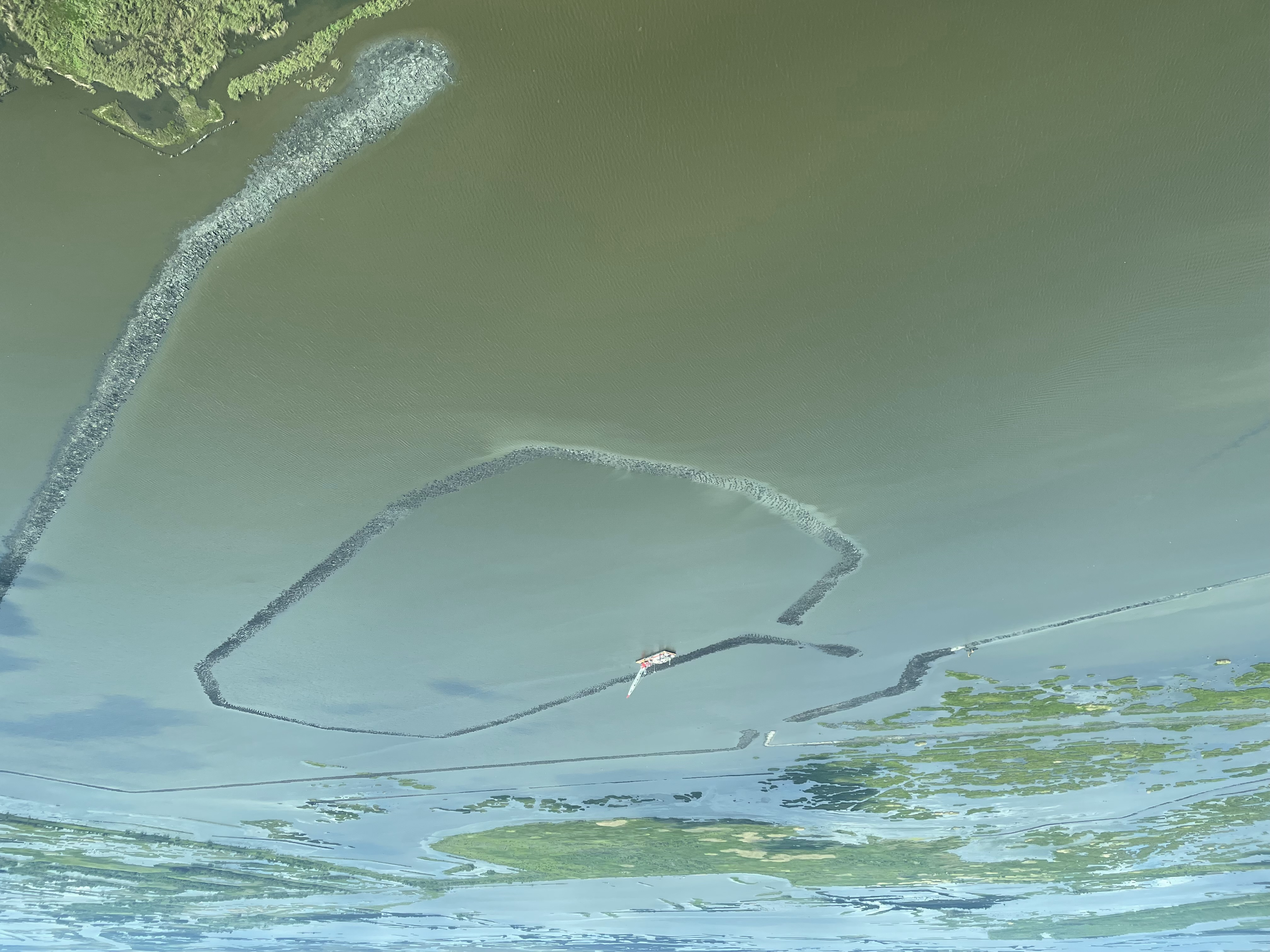 An attempt by Louisiana coastal officials to rebuild shoreline lost to coastal erosion, as they fight to keep the state’s coast livable amid. Photo: Xander Peters, 2023. 