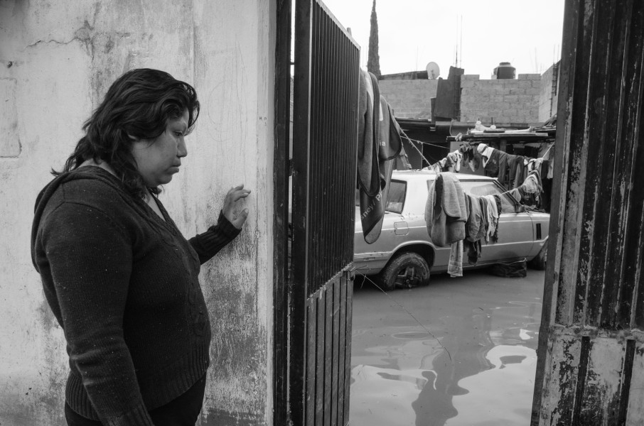 A woman walks across a flooded street in Mexico City.