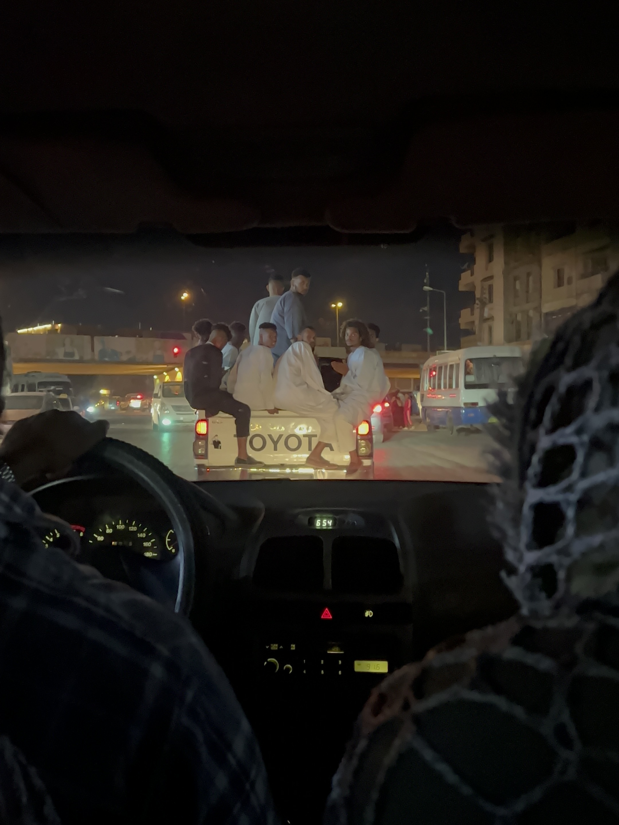 A group of friends or family members ride in the back of a pickup truck. Khartoum, December 24, 2022. Photo courtesy of the author. 