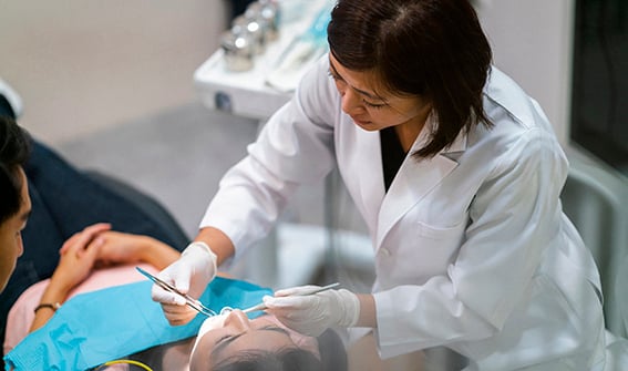 Dentist checking patient’s teeth